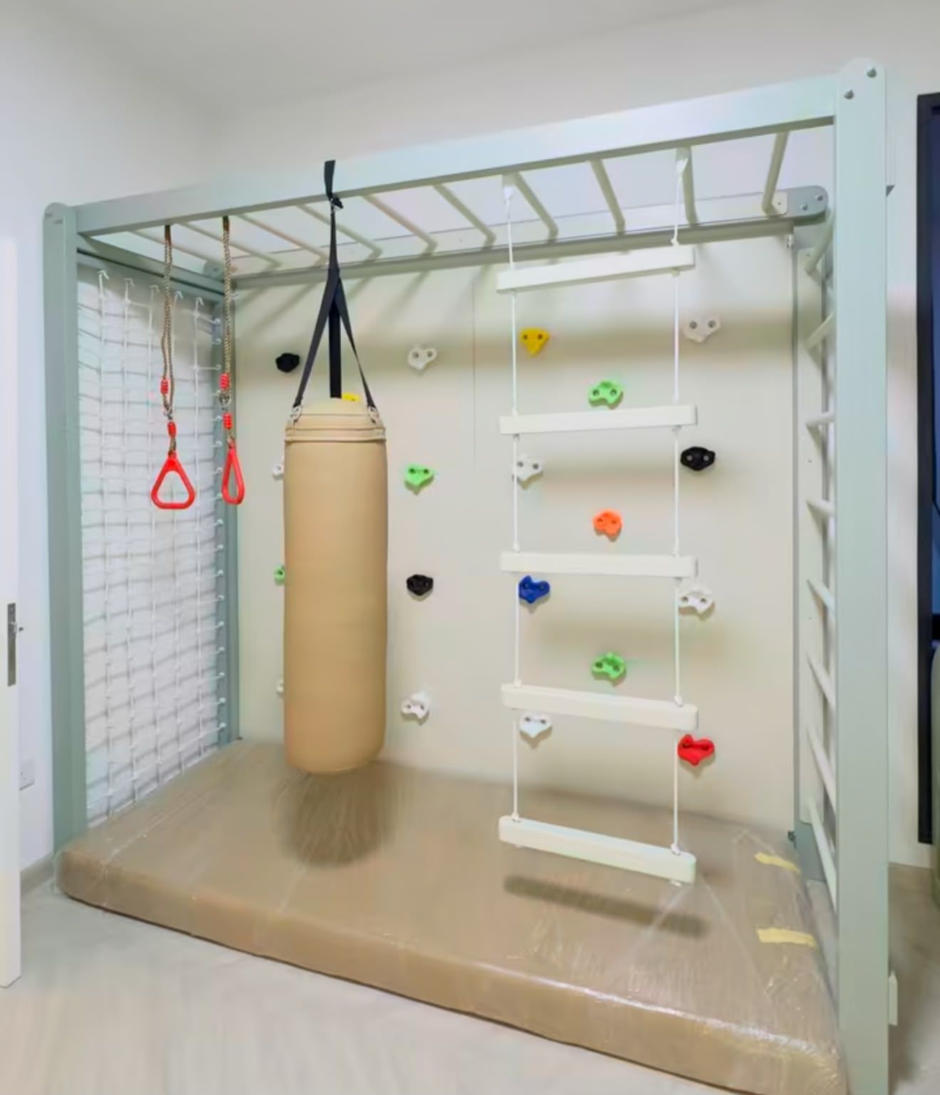 Indoor kids gym wall with climbing holds